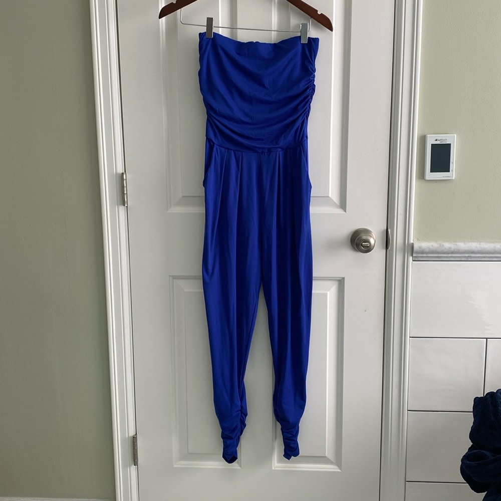 Electric blue jumpsuit with pockets, size extra small.